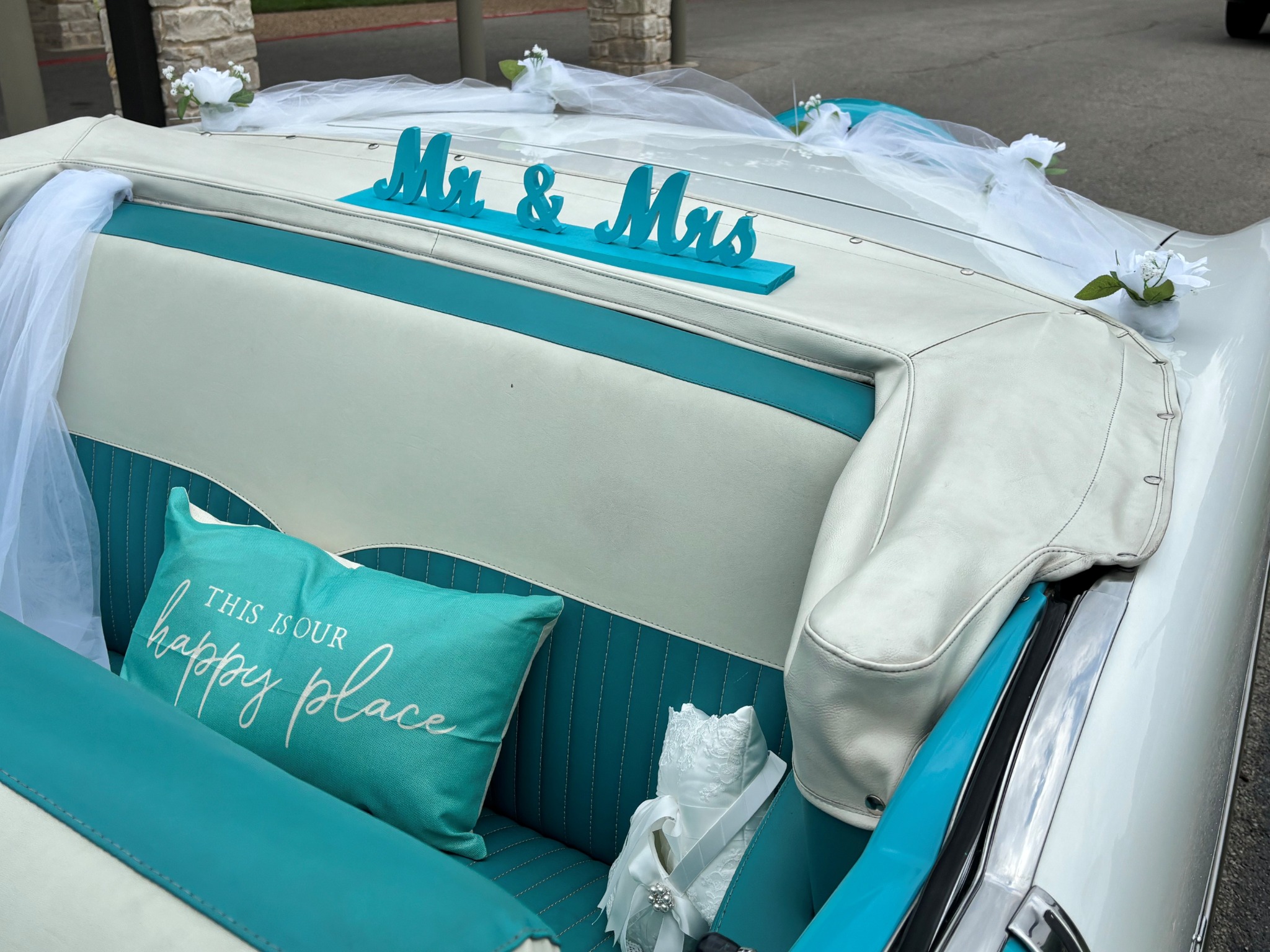 Ole' Belle's turquoise and white back seat decorated for newlyweds