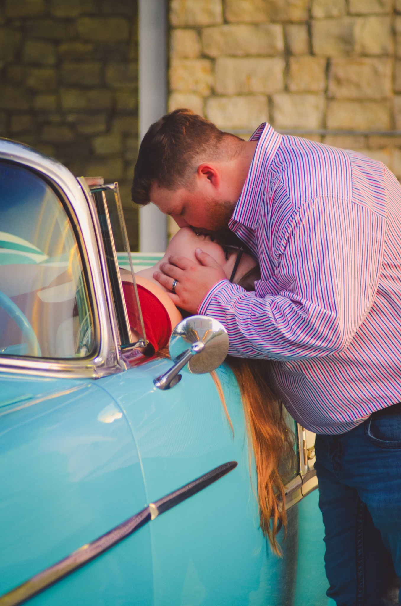 Engaged couple sharing a kiss at Ole' Belle's passenger door