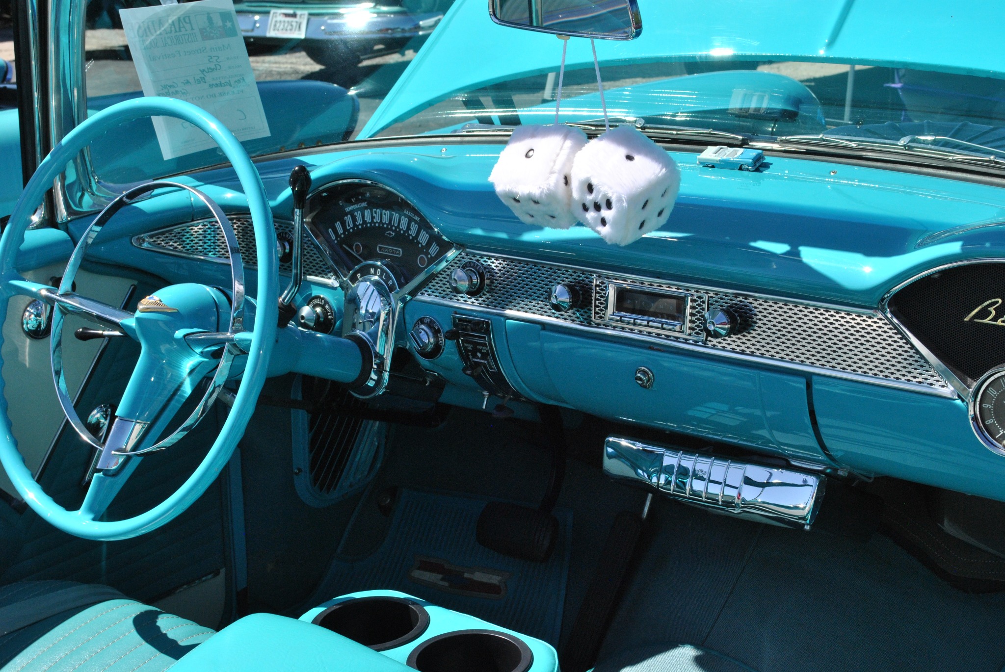 Ole' Belle's restored turquoise dashboard, steering wheel and fuzzy dice