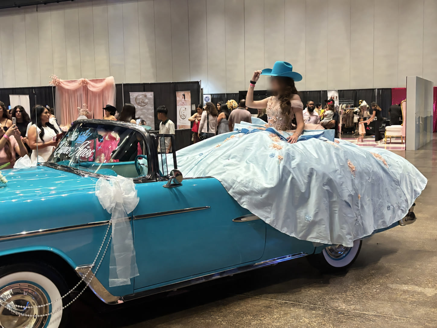 Ole' Belle paired with a turquoise hat and blue quinceañera gown at an expo